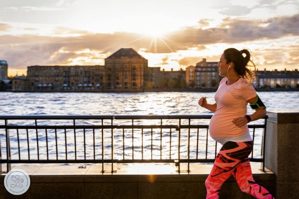 Pregnant woman running along memorial drive